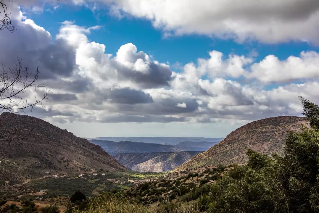 A green Atlas valley under a big cloudy sky