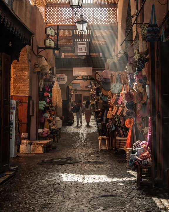 A sunlit souk alley in the Marrakech medina
