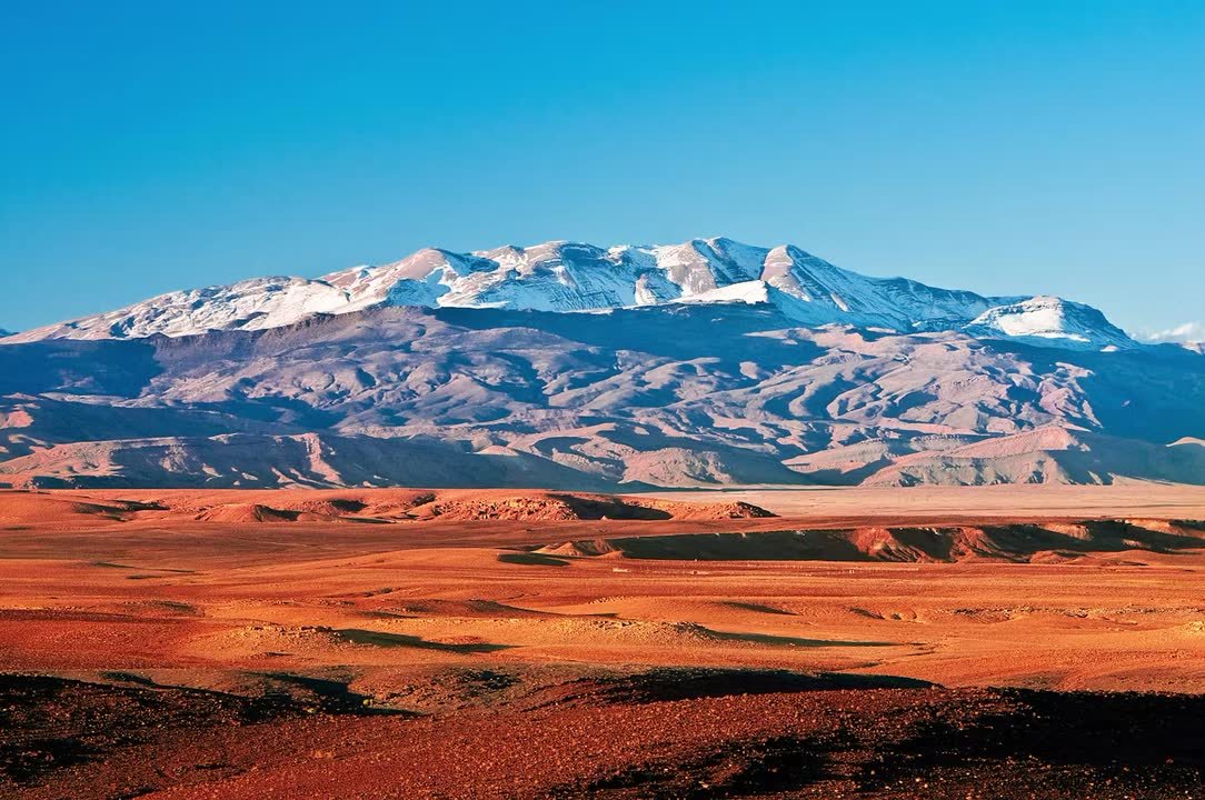 Snow on the High Atlas above red desert